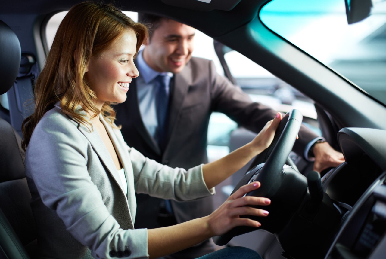 two teens in a car with one driving the vehicle