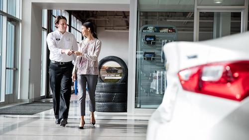 Certified Chevy Technician handing customer her keys