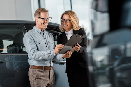 Man finalizing sale of his new car