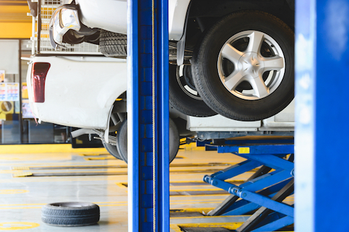 Several trucks getting serviced at a mechanic's shop