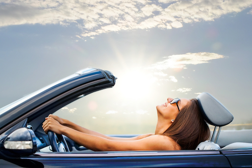 happy woman in her new car