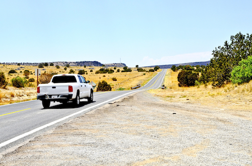 Used truck on an empty stretch of road