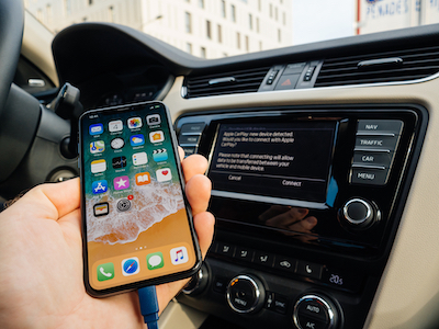 man synching phone to Apple CarPlay