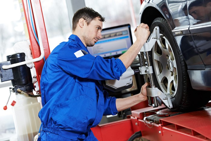 Mechanic performing a front end alignment