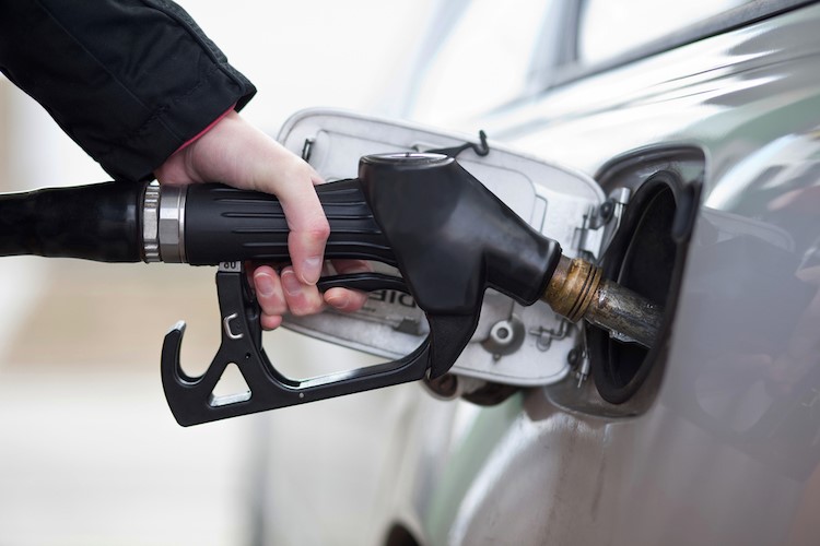 A person filling up their vehicle with gas