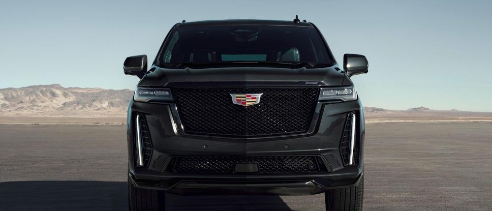 22024 Escalade V 20th Anniversary AWD seen in Black Diamond Tricoat (GLK) with 6.2L Supercharged engine (LT4); dead front view; mountains in background