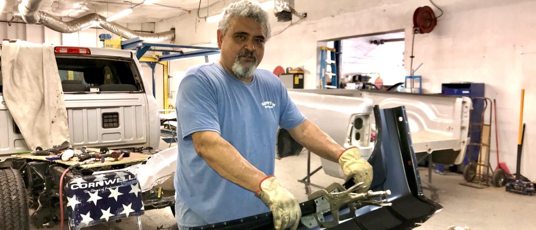 Technician working on vehicle restoration