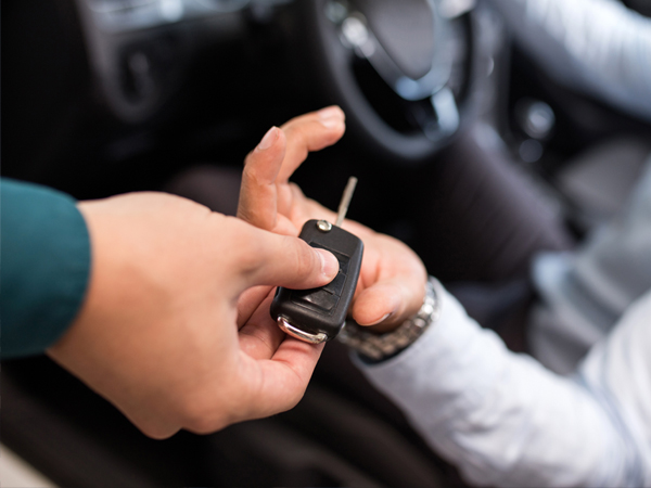 handing over car keys to customer