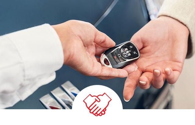 Man taking the keys to his new car with swapping keys icon