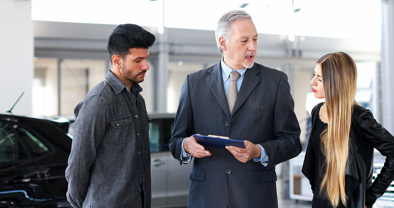 Customers speaking with a GMC dealer