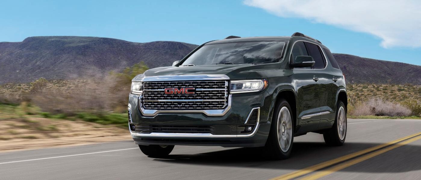 2023 GMC Acadia Denali exterior driving on desert highway