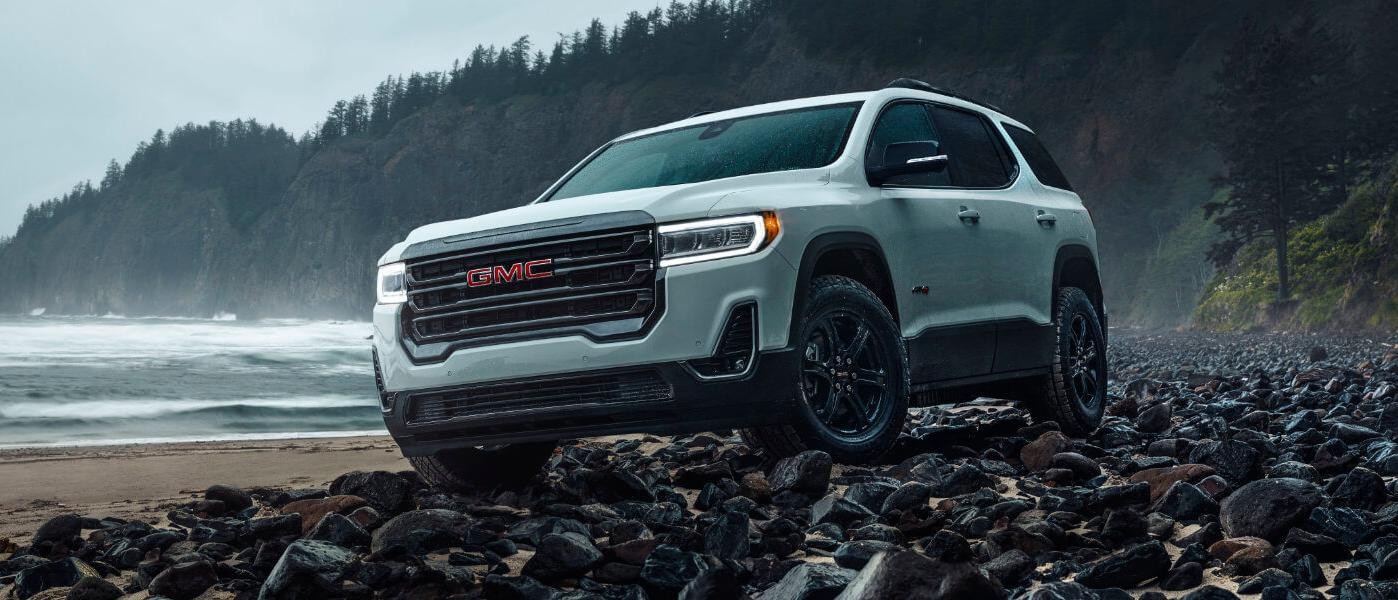 2023 GMC Acadia exterior on beachfront rocks