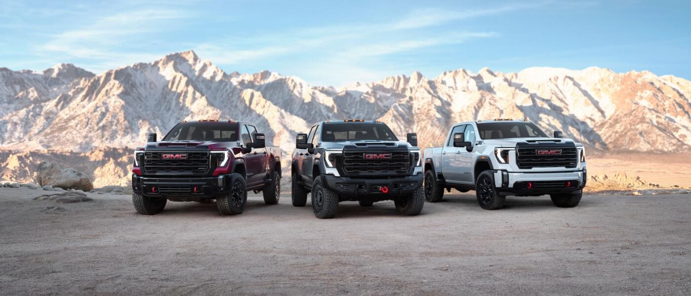 2024 GMC Sierra 2500's parked in front of mountains