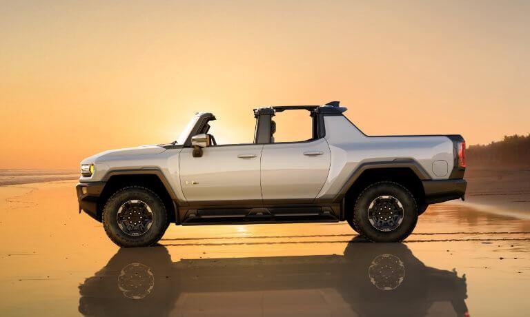 2022 GMC Hummer EV Truck exterior on beach at sunset