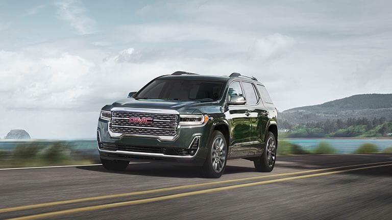 2021 GMC Acadia driving on a ridge