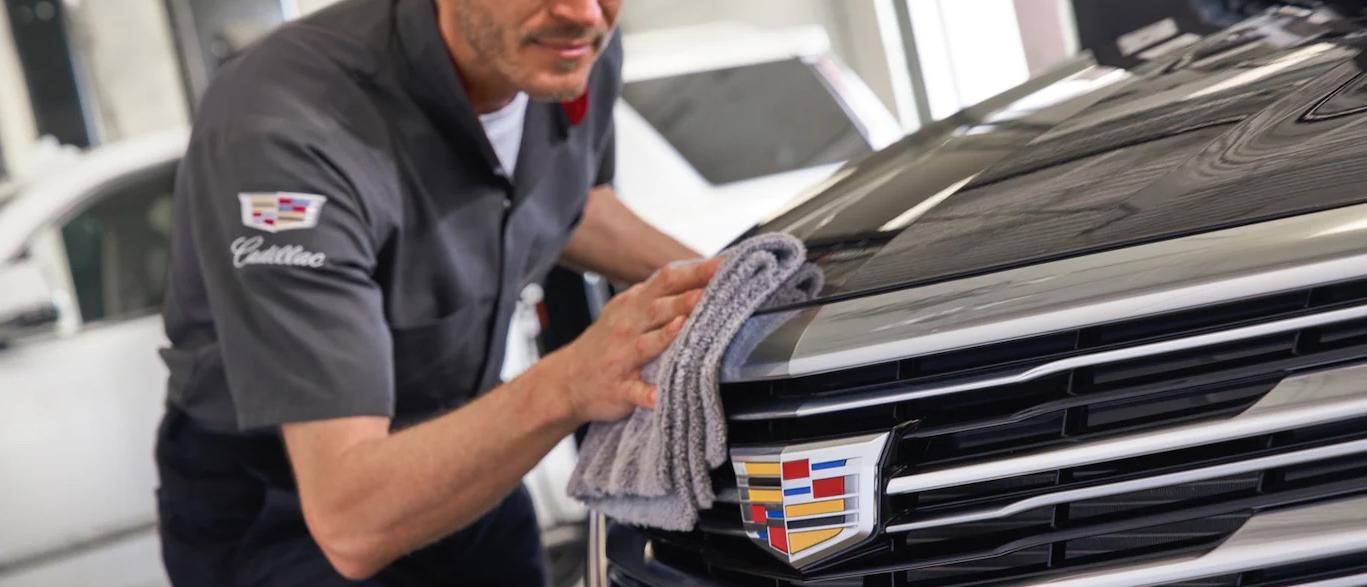 Technician cleaning Cadillac vehicle