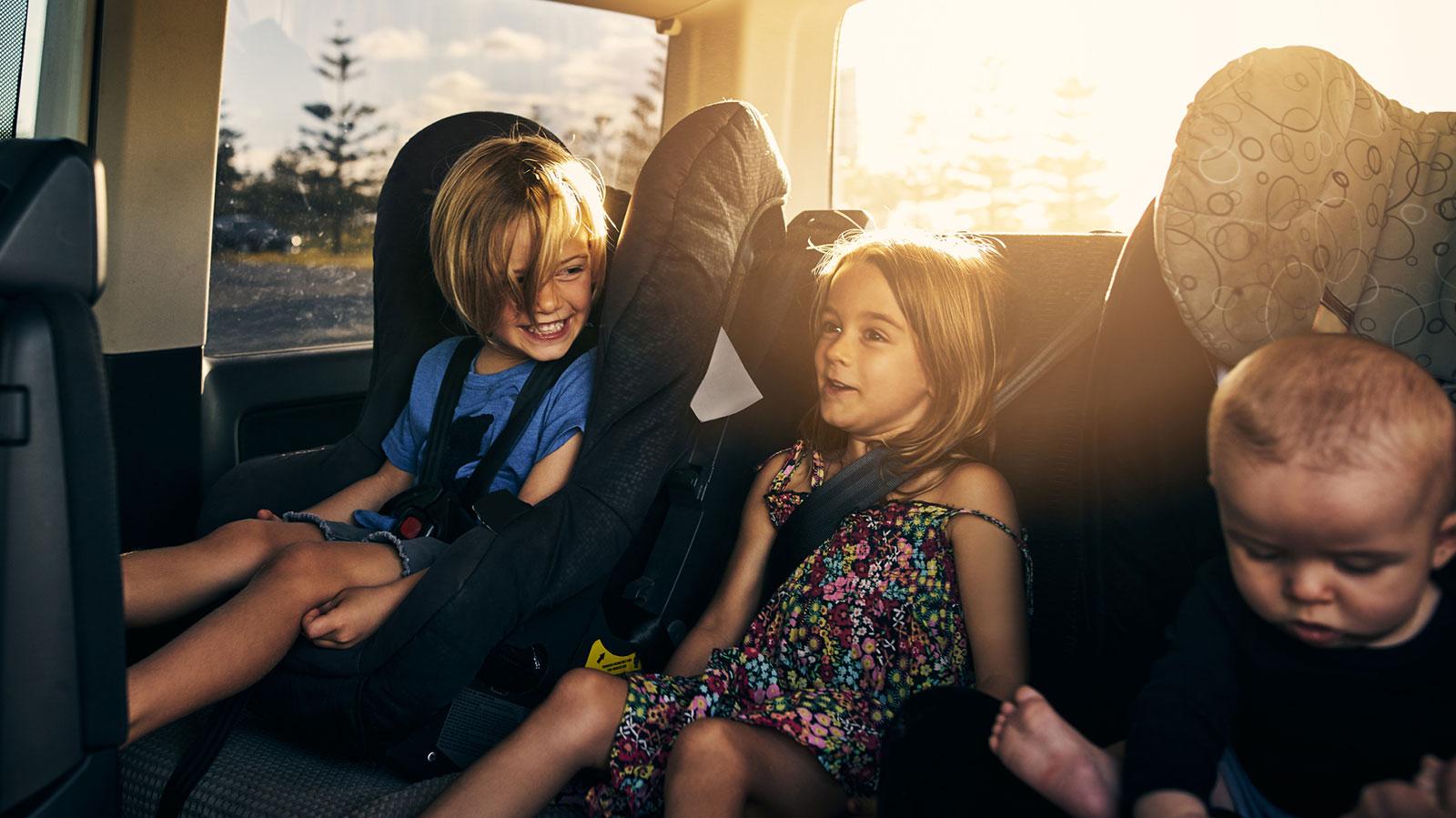 children in back seat of vehicle