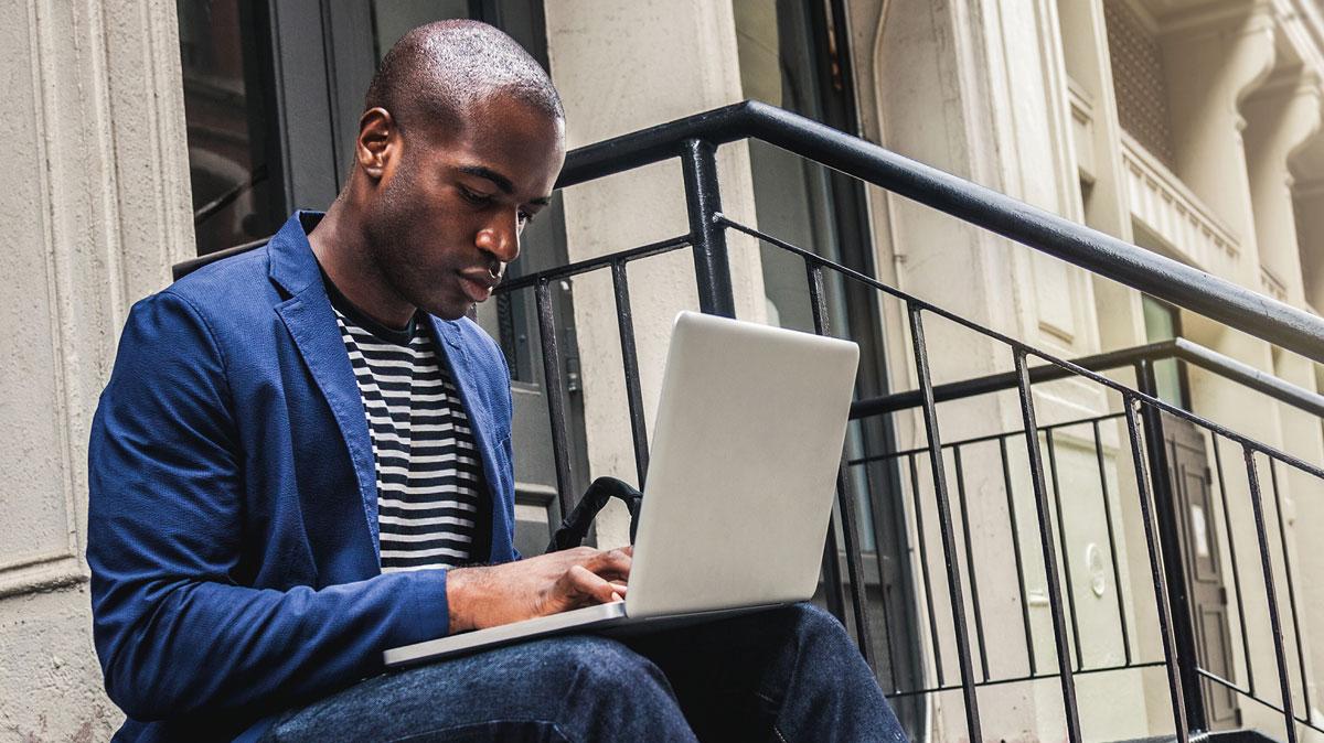 Man laptop city stairs