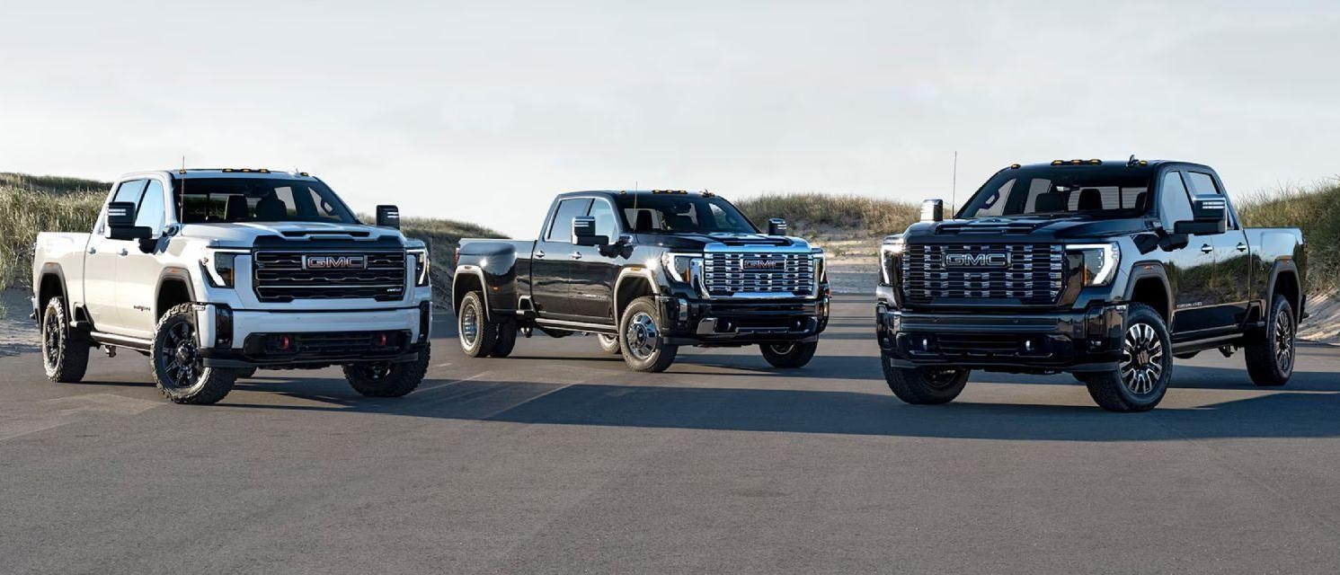 2025 GMC Sierra HD Family parked in a country parking lot