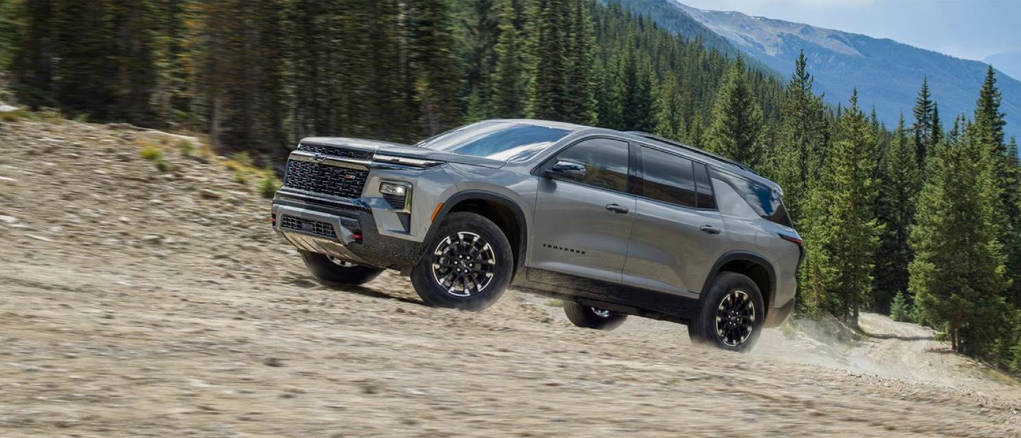 2025 Chevy Traverse driving up a hilly road