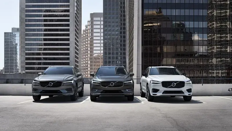 Three Volvo SUVs lined up on a roof