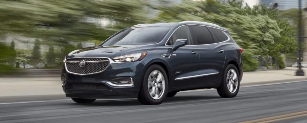 2021 Buick Enclave driving through blurred forest
