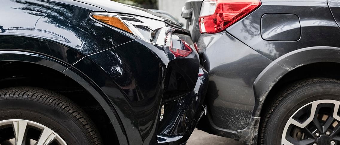 Two Cars in an accident with broken bumper and frame