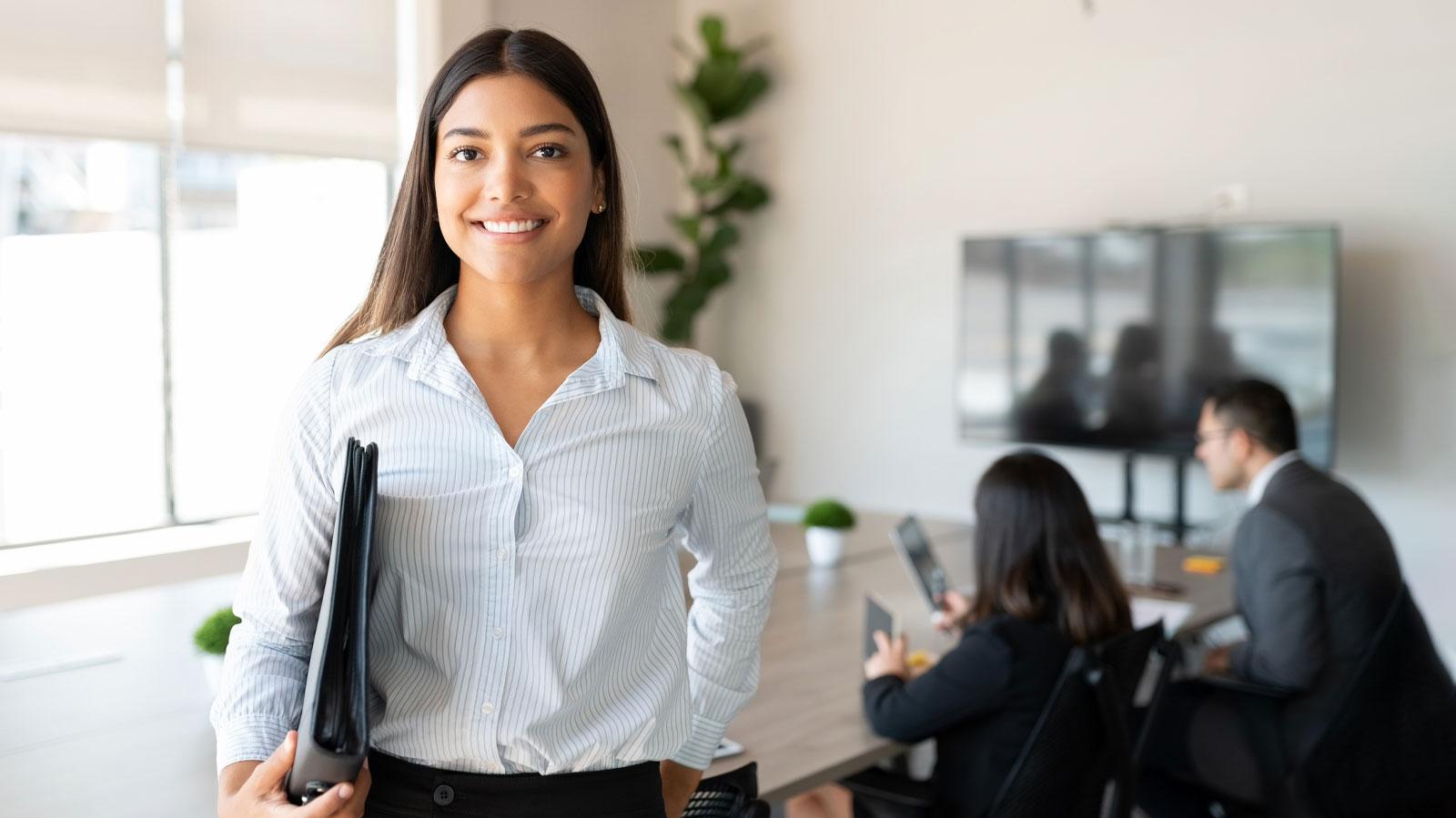 Hispanic female business professional in office boardroom