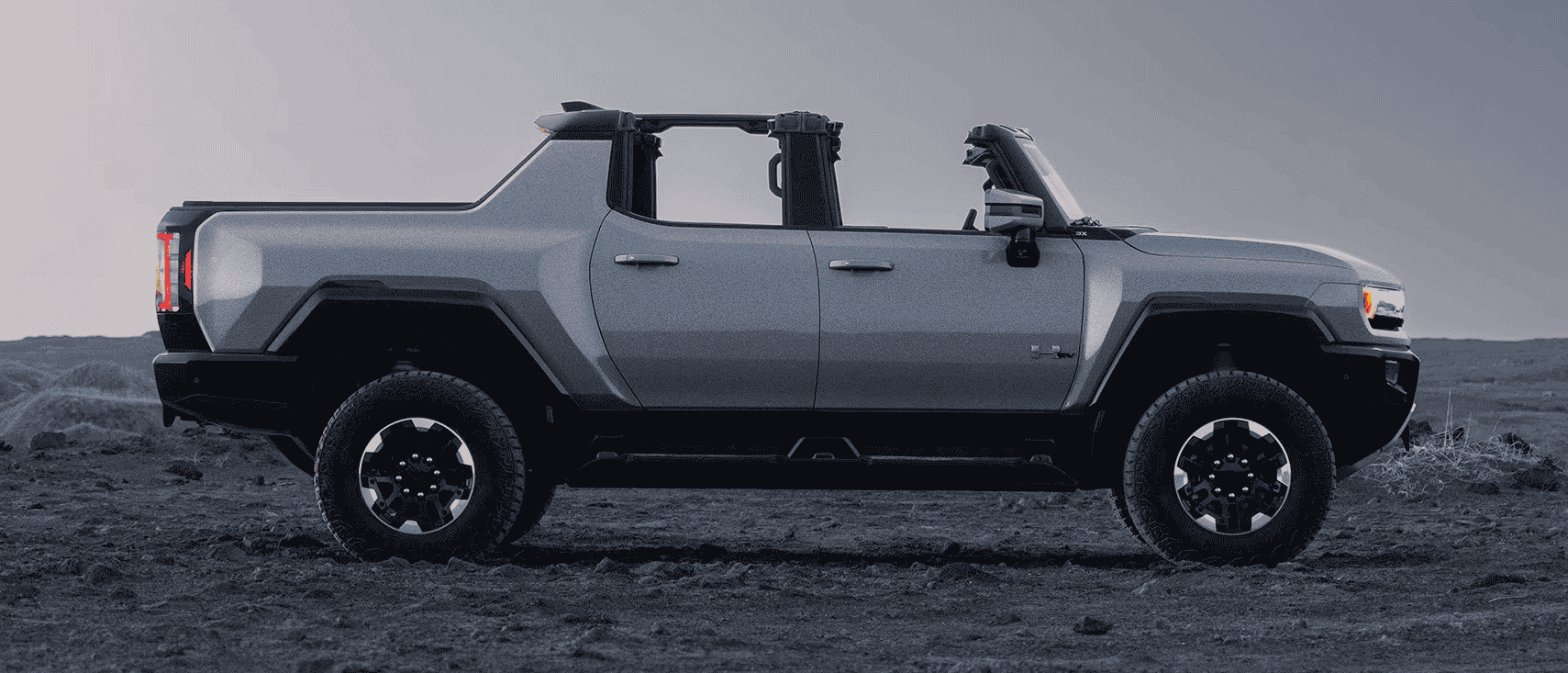 The GMC Hummer EV truck with its roof and doors off.