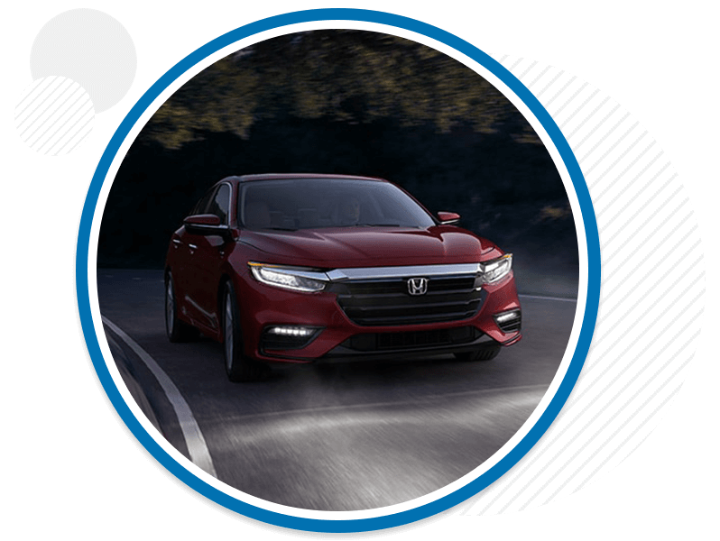 Honda vehicle driving down a road.