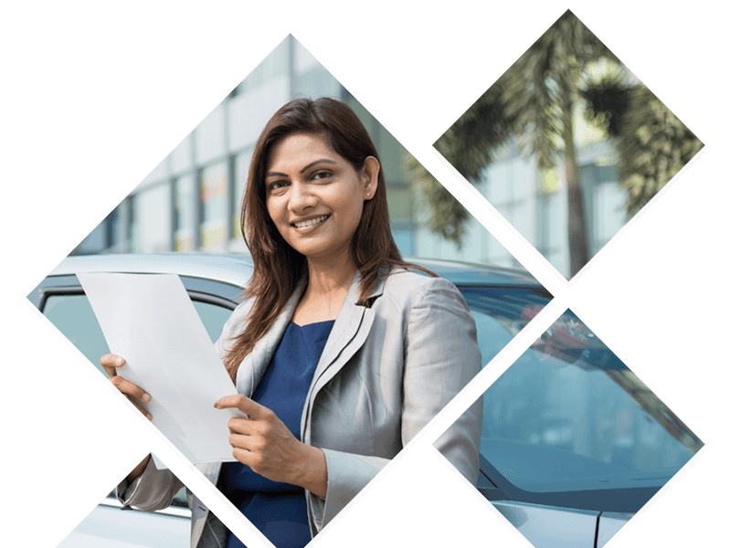 Woman holding paperwork leaning against a car.