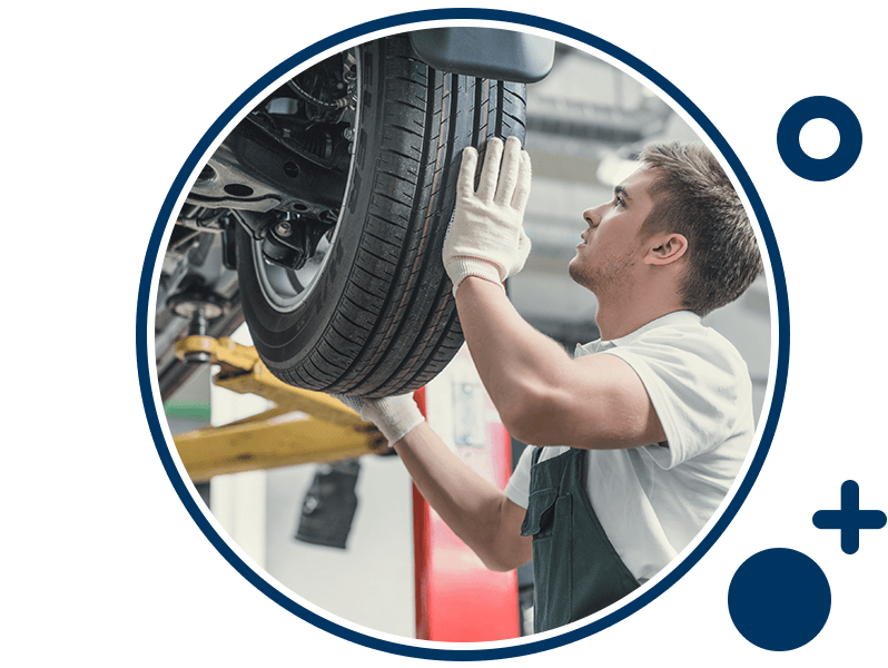 Body Shop Technician installing wheel