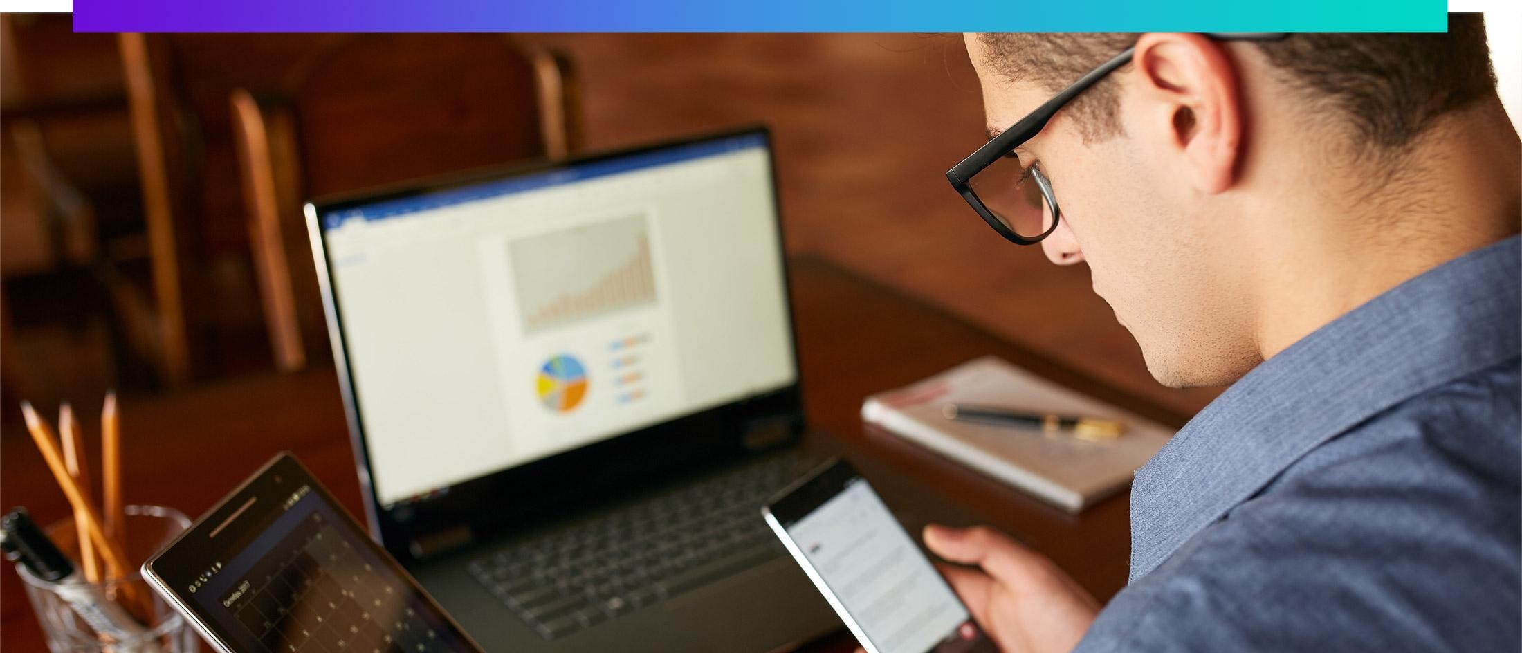 Person looking at a phone, computer and tablet
