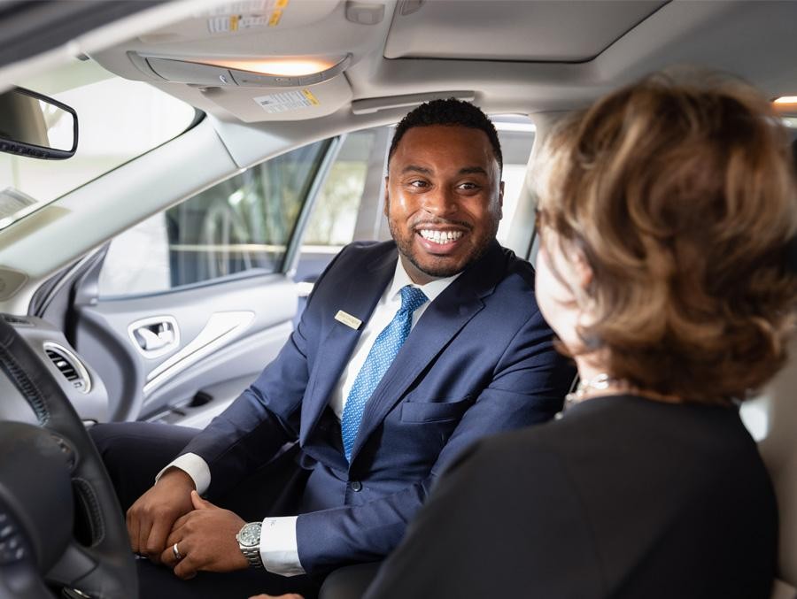 Product specialist showing details of a vehicle