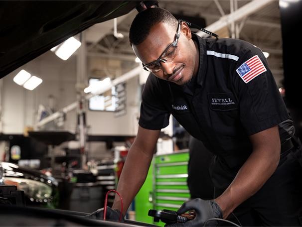 Technician under car hood