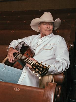 Alan Jackson with guitar in seating