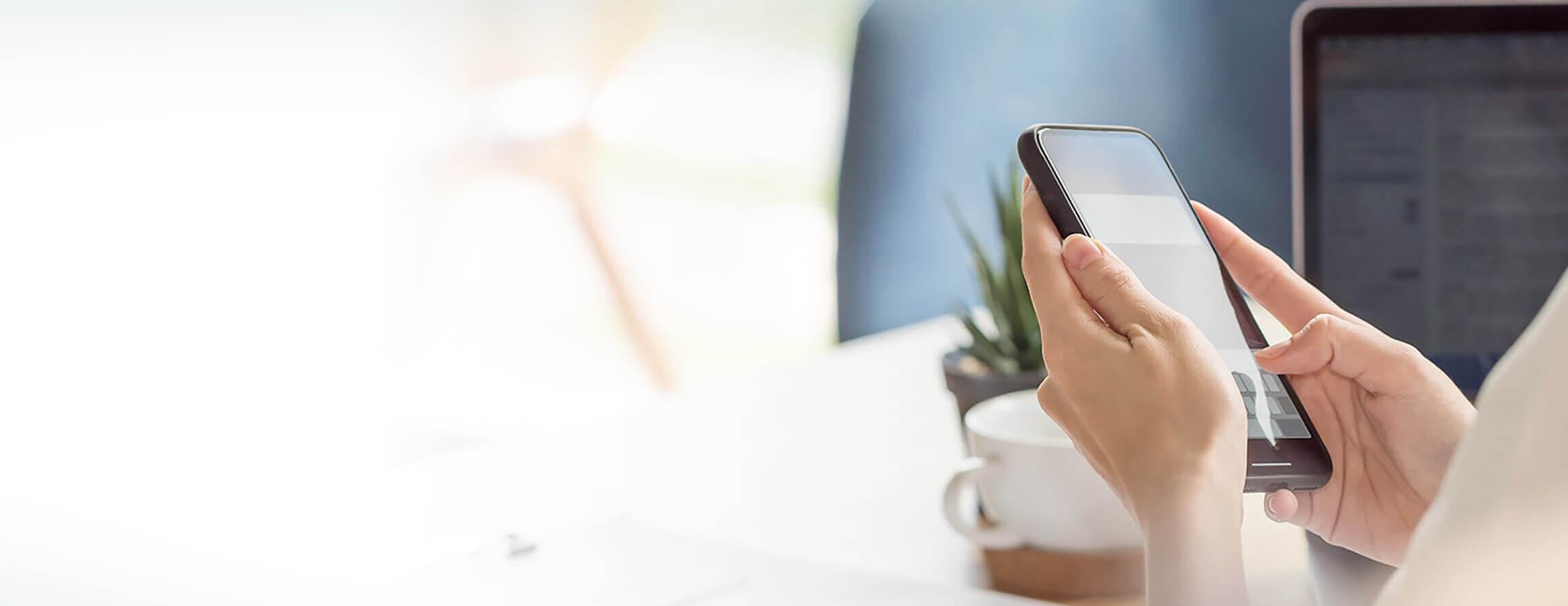 Woman using a phone at her desk