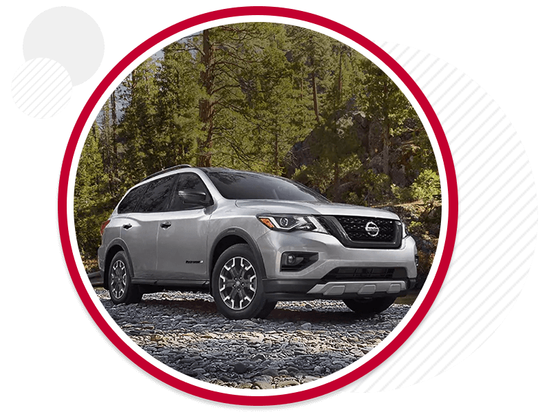 Nissan vehicle parked on a gravel road