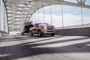 2021 Nissan TITAN driving on a bridge