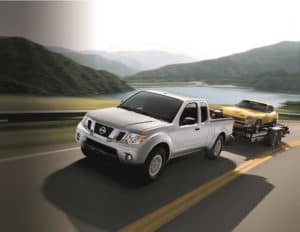 Frontier towing a yellow car