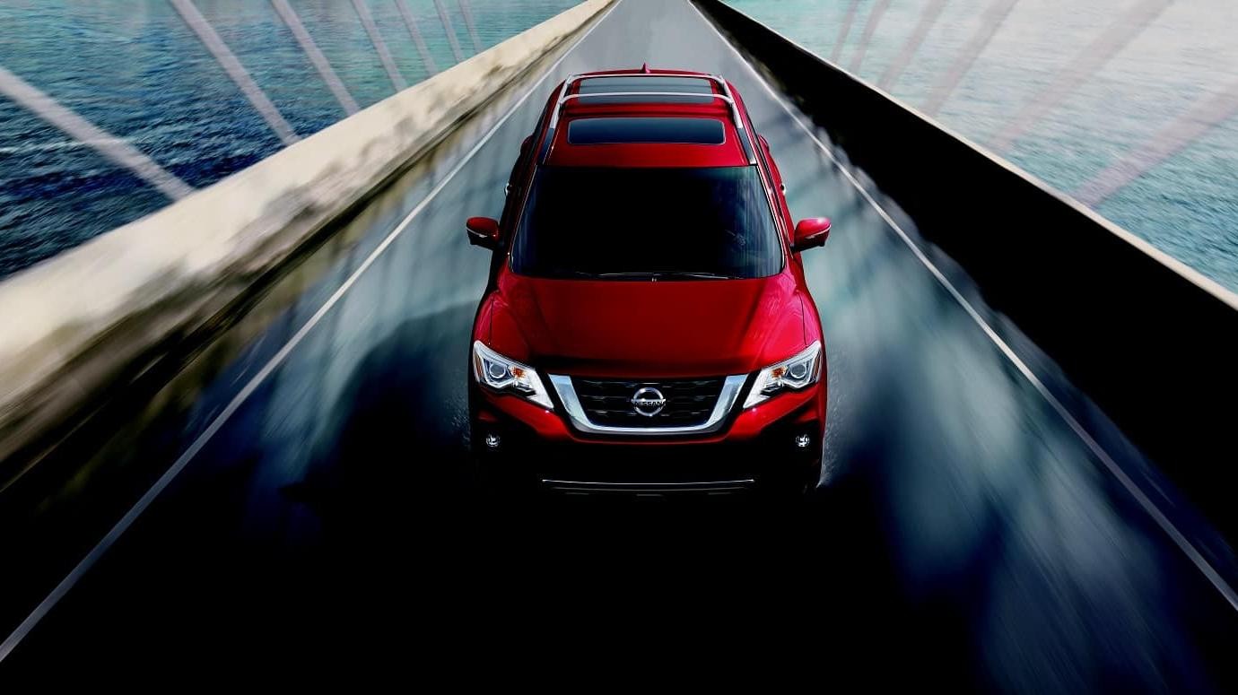 2020 Red Nissan Pathfinder Cruising on a Bridge