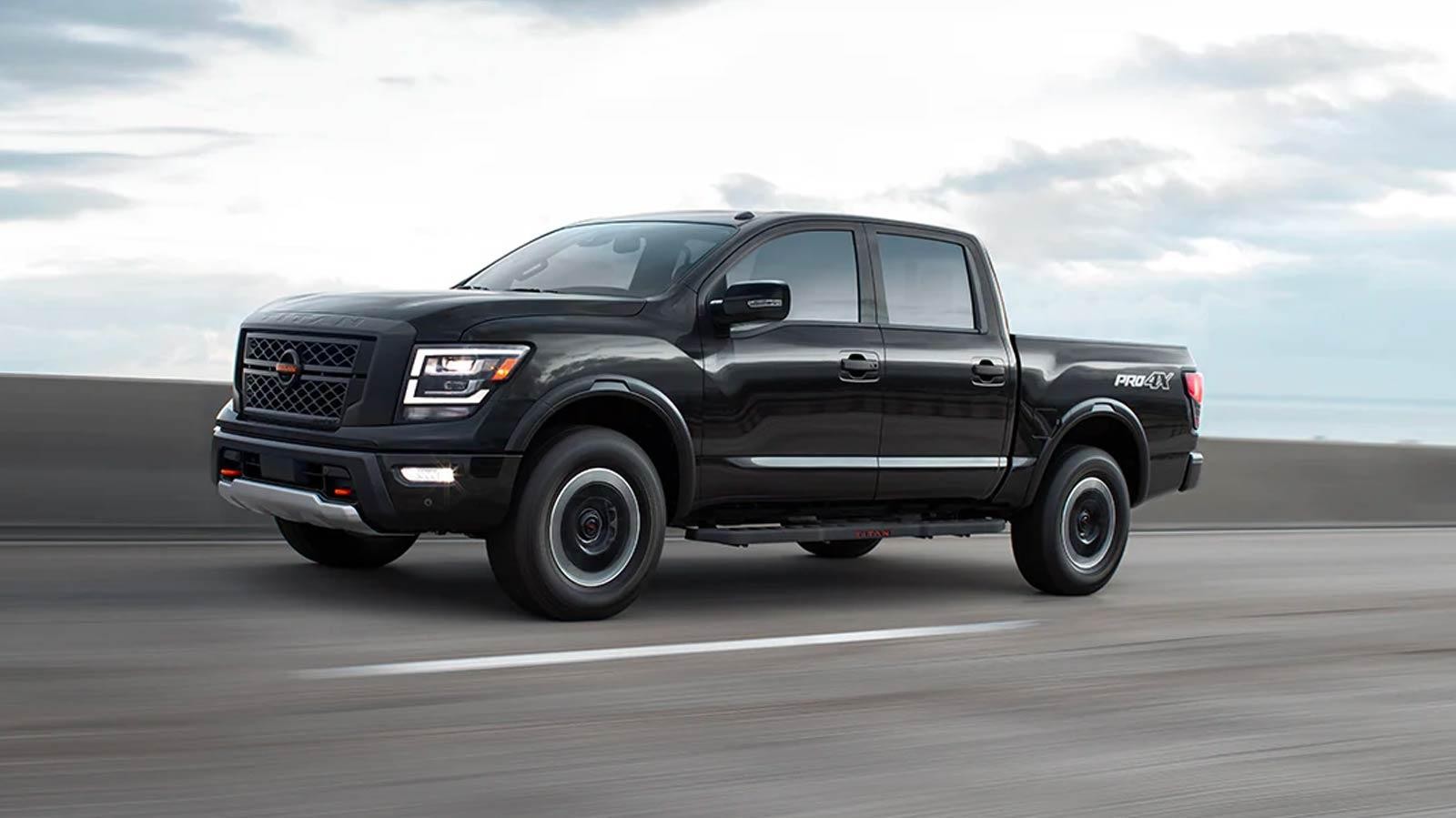 Black Nissan Titan Truck Cruising on road