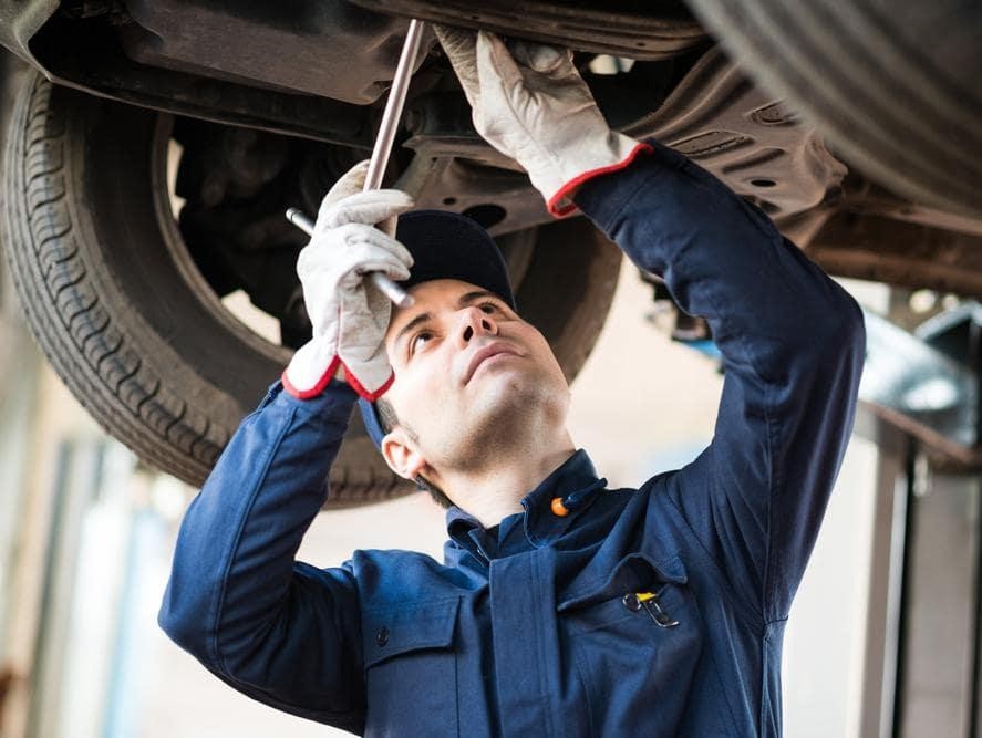 Technician servicing car