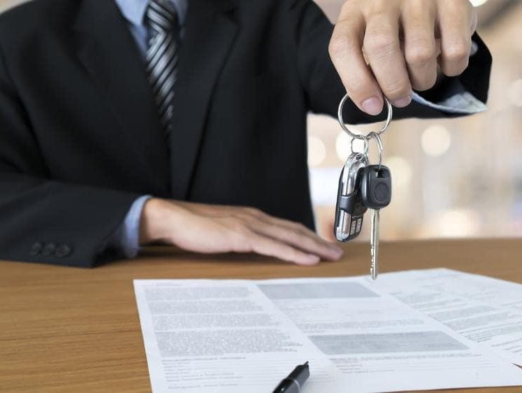 Salesperson showing car keys