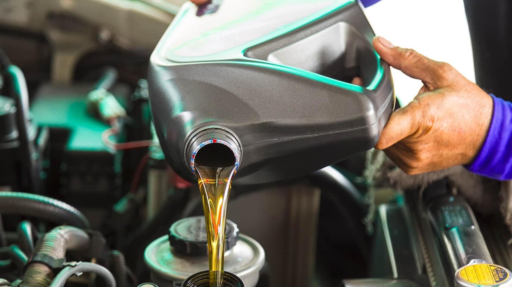 Technician changing oil