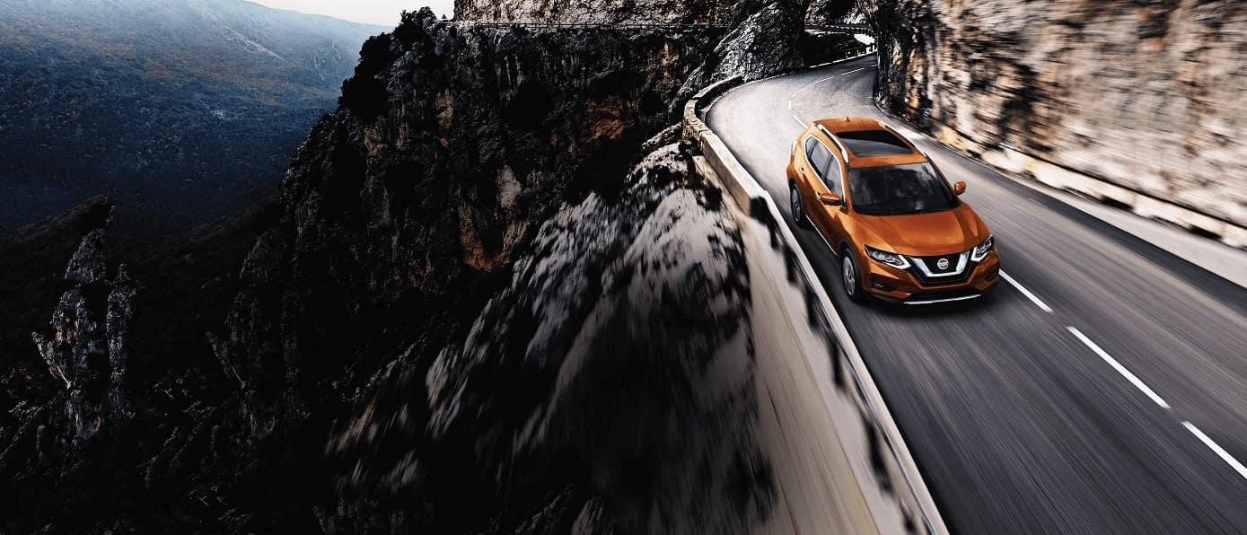 Nissan Rouge driving on bridge