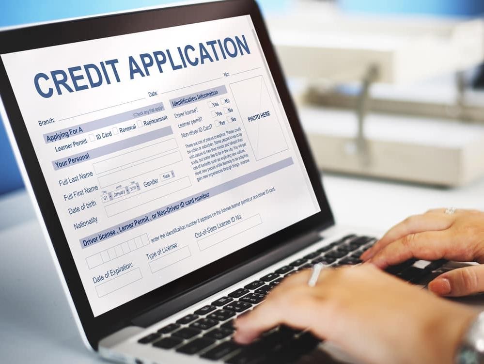 Man working on credit application on a laptop