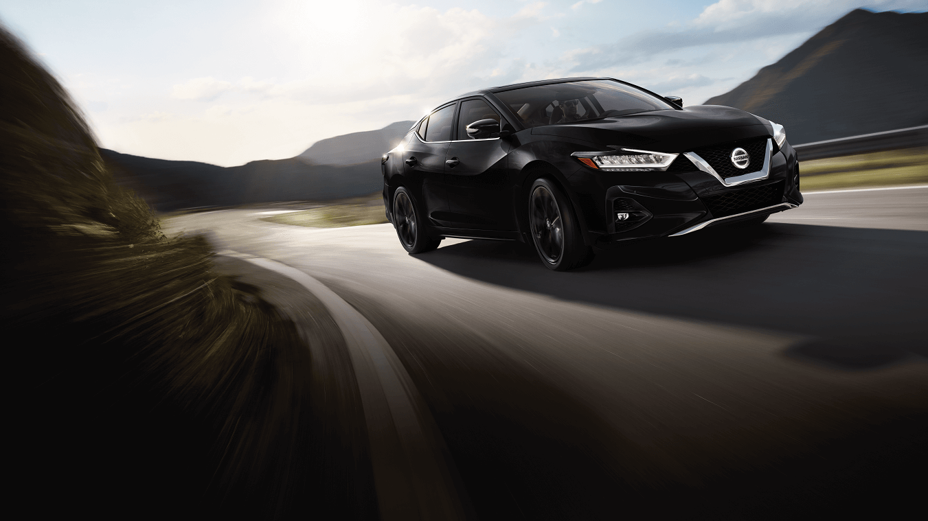 Nissan Maxima driving on road
