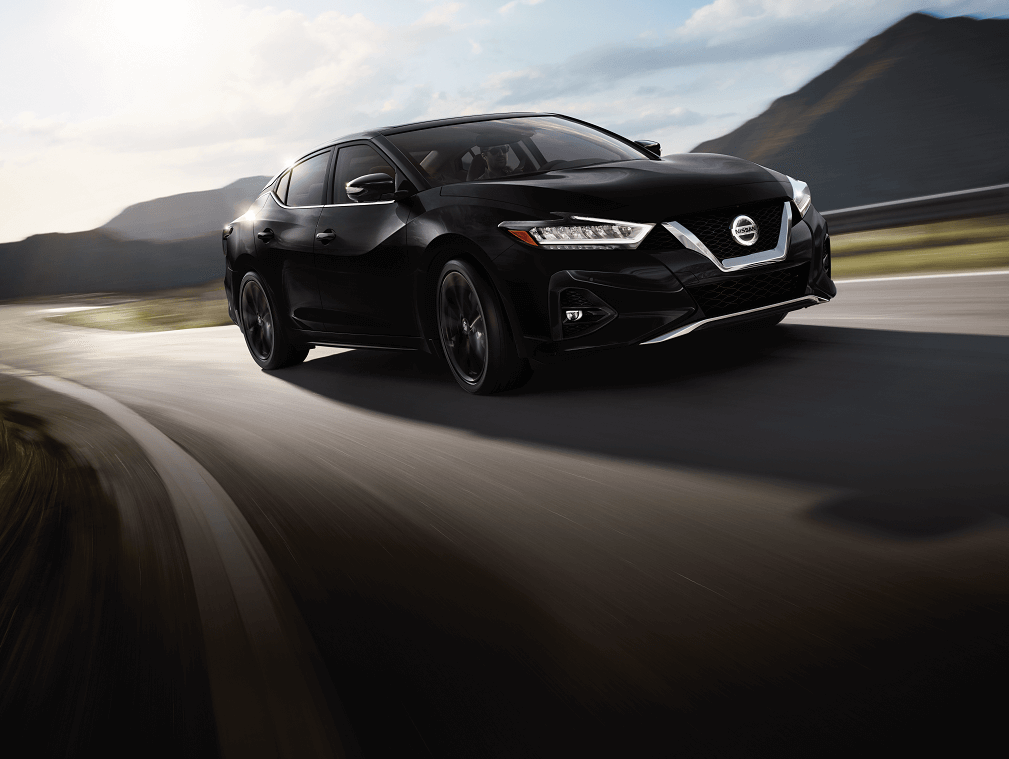 Nissan Maxima driving on road