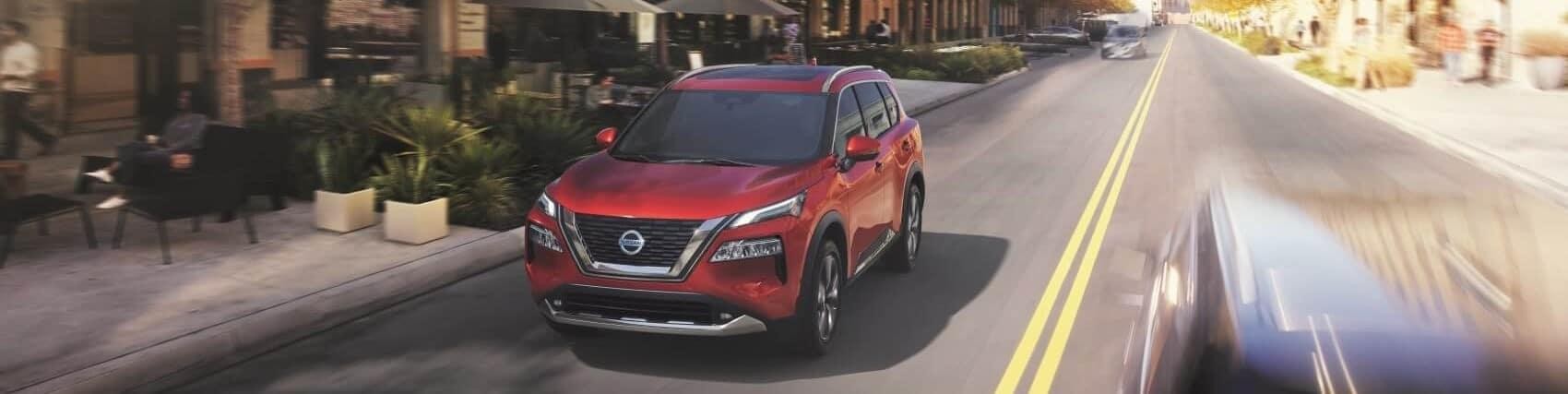 Nissan Rouge driving through road